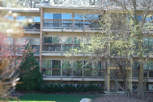 Front view of a multi-story building with balconies.