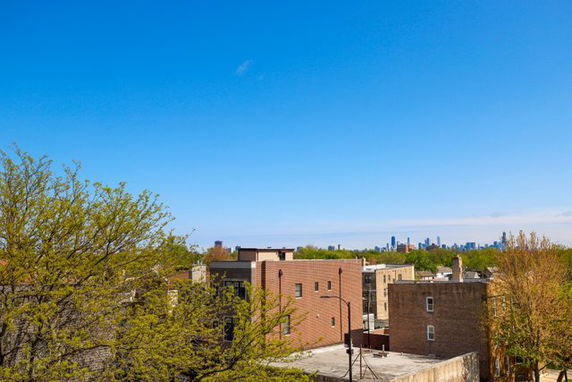 Panoramic view of buildings with a city skyline in the background.