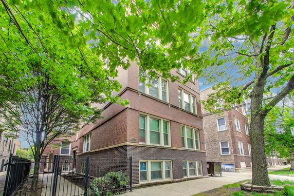 Front view of a multi-story brick apartment building.