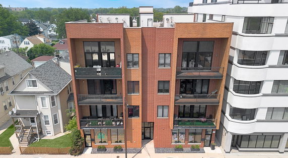 Front view of a multi-story brick apartment building.