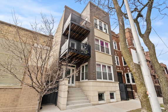 Front view of a multi-story building with balconies.