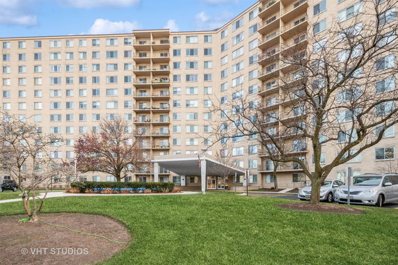 Front view of a multi-story apartment building with balconies.