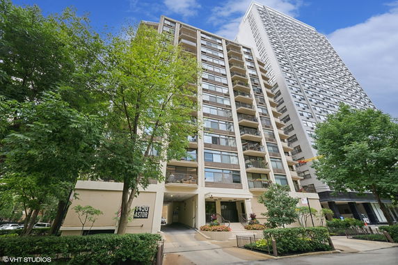 Front view of a multi-story residential building with balconies.