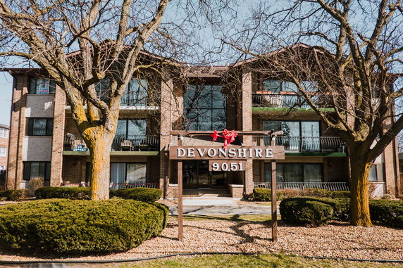 Front view of a three-story apartment building named Devonshire.