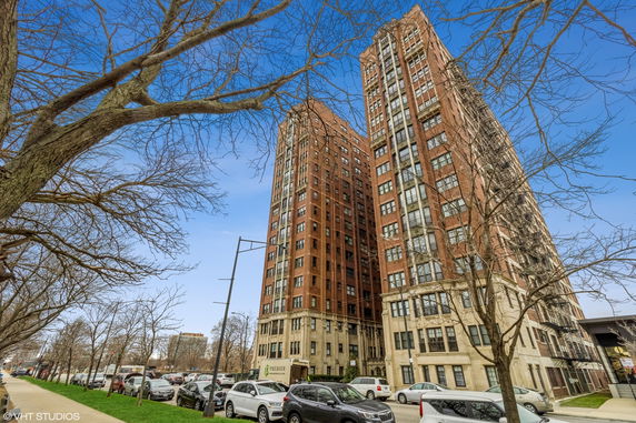 Front view of a tall brick apartment building.
