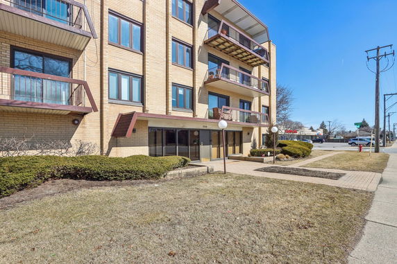Front view of a multi-story residential building with balconies.