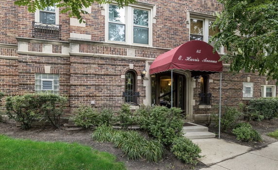 Front view of a brick building with an entrance canopy.