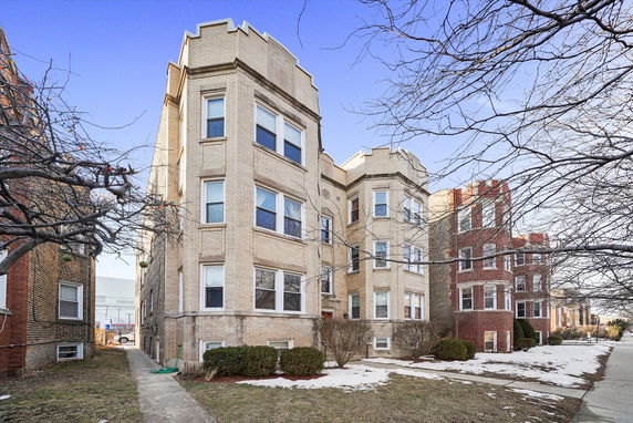 Front view of a multi-story brick apartment building.