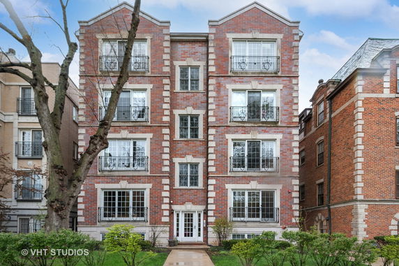 Front view of a four-story brick apartment building.