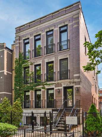 Front view of a three-story brick townhouse.