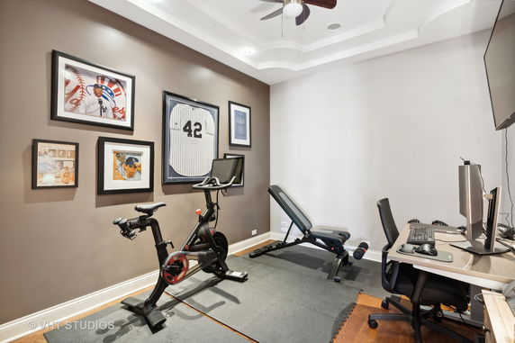 Indoor gym area with exercise bike and weight bench.