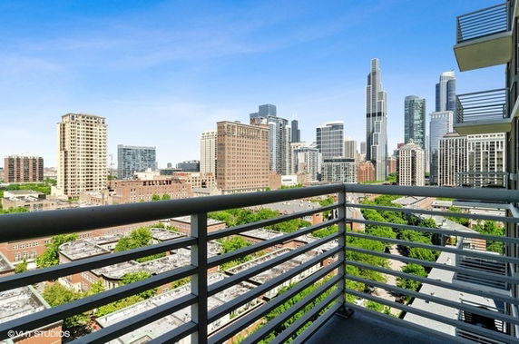 Panoramic view of a cityscape from a building balcony.
