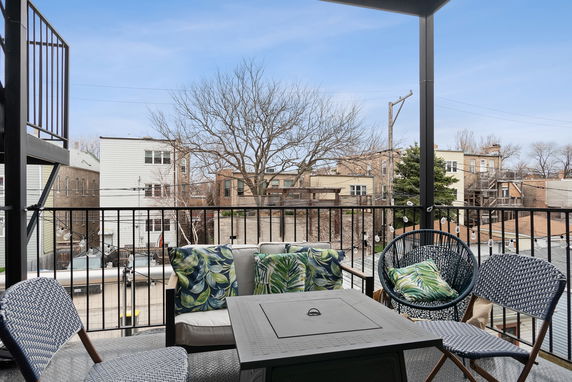 Outdoor seating area with a view of surrounding residential buildings.