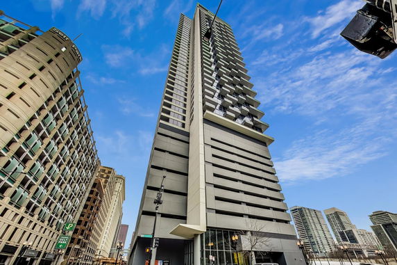 Front view of a modern high-rise building with balconies.