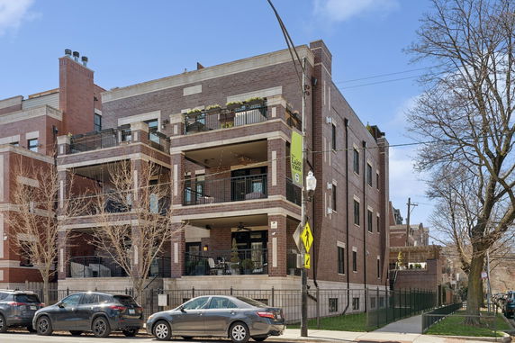 Front view of a multi-story apartment building with balconies.