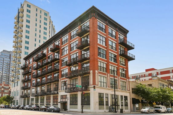 Front view of a multi-story residential building with balconies.