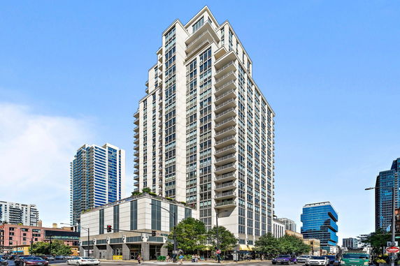 Front view of a high-rise building with multiple balconies.