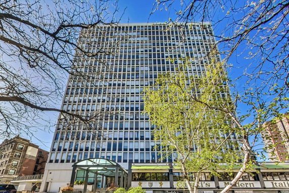 Front view of a tall multi-story building with glass and concrete facade.