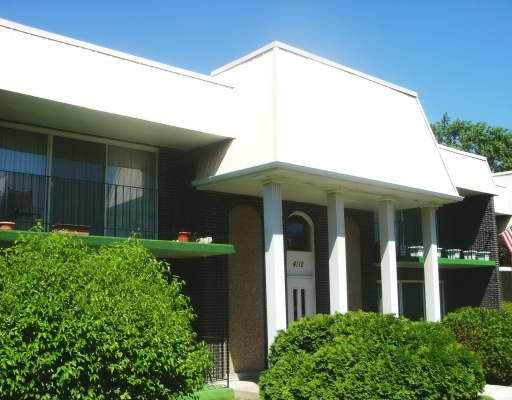 Front view of a two-story building with large windows and columns.