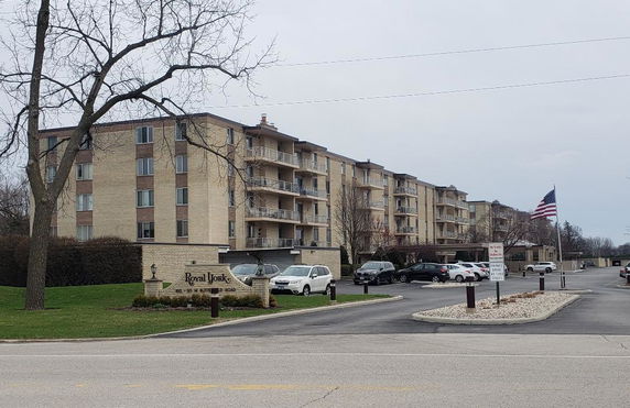 Front view of a multi-story apartment building with balconies.