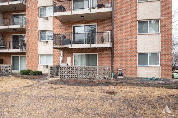 Front view of a multi-story brick building with balconies.