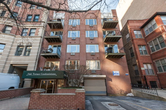 Front view of a multi-story condominium building with balconies.