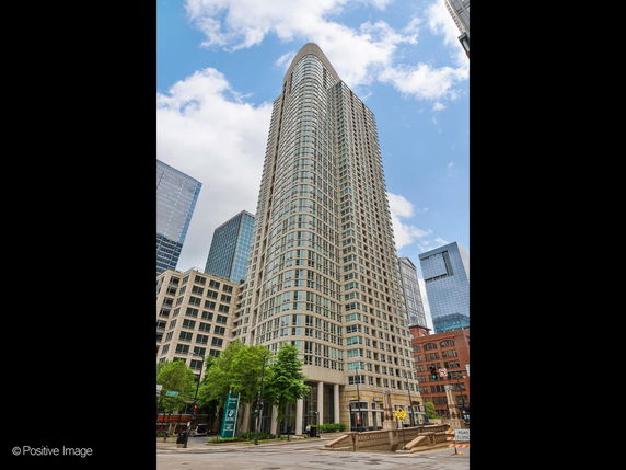 Front view of a tall, multi-story building with a modern design.
