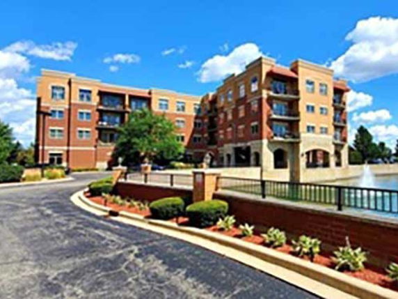 Front view of a multi-story apartment building with balconies.