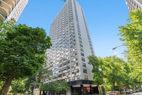 Front view of a multi-story apartment building with numerous windows and a modern design.
