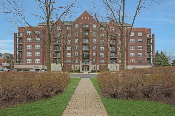 Front view of a multi-story brick apartment building.