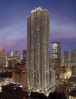 Front view of a tall skyscraper at dusk in a cityscape.