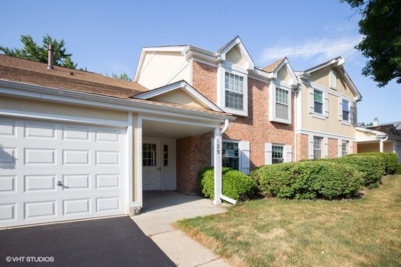 Front view of a two-story house with attached garage.