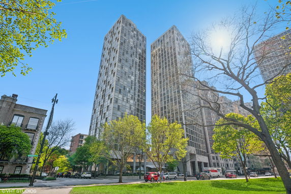 Front view of two tall residential buildings with a modern design.