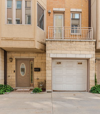 Front view of a townhouse with a garage and entrance door.