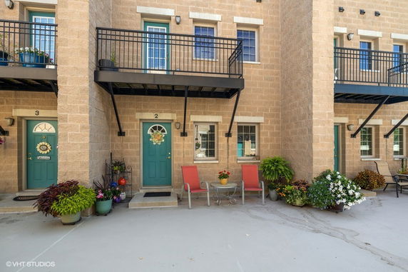 Front view of a building with multiple doors and balconies.