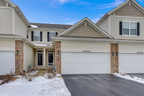 Front view of a two-story house with a double garage.