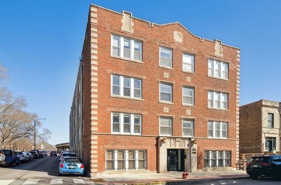 Front view of a multi-story brick apartment building.