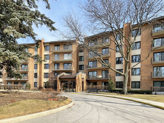 Front view of a multi-story residential building with balconies.