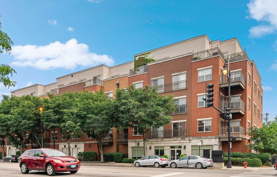 Front view of a multi-story apartment building with balconies.
