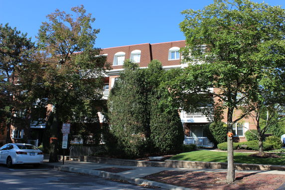 Front view of a multi-story building with balconies.