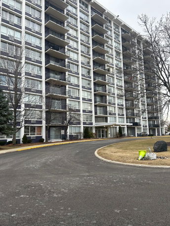 Front view of a multi-story residential building with balconies.