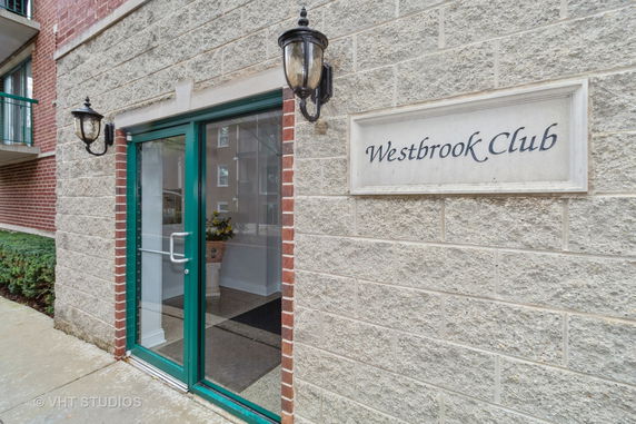 Front view of a building entrance with 'Westbrook Club' sign.