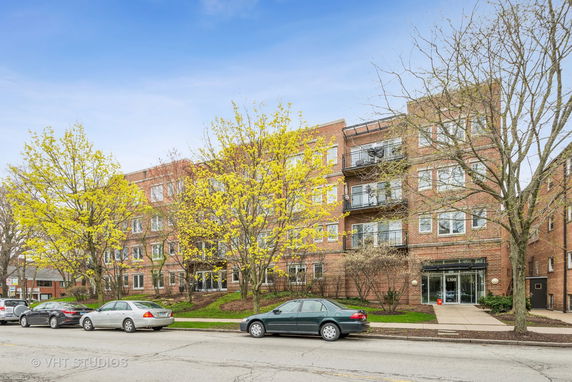 Front view of a multi-story brick building with balconies.