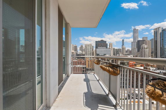 Balcony view overlooking city skyline with modern skyscrapers.