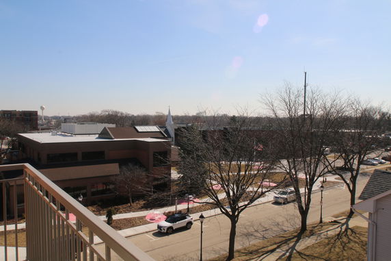 Panoramic view showing rooftops and surrounding area from a higher vantage point.