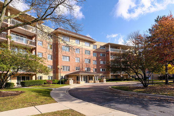 Front view of a multi-story residential building with balconies.