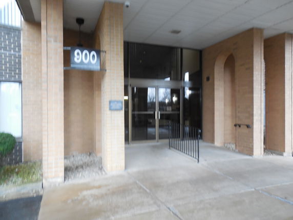 Entrance view of a building with brick exterior and glass doors.