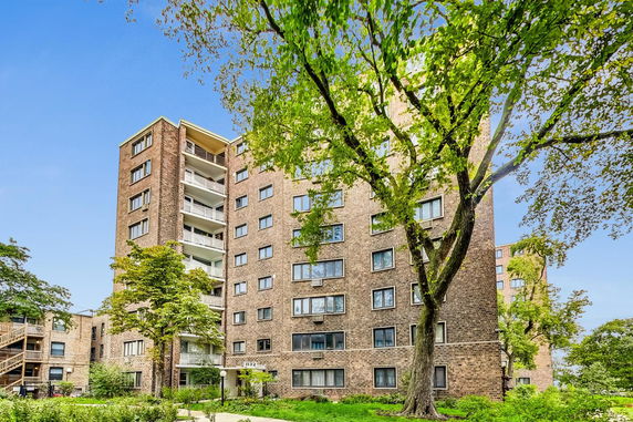 Front view of a multi-story brick apartment building.