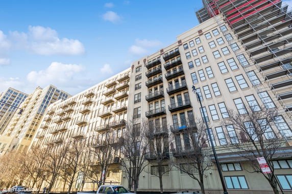 Front view of a multi-story apartment building with balconies.