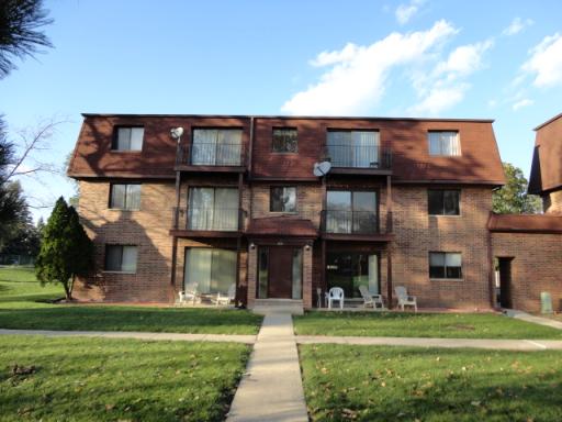 Front view of a three-story brick apartment building.
